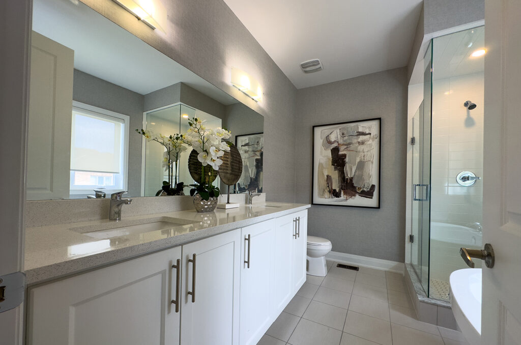 Ensuite bathroom with double sink and walk in shower.
