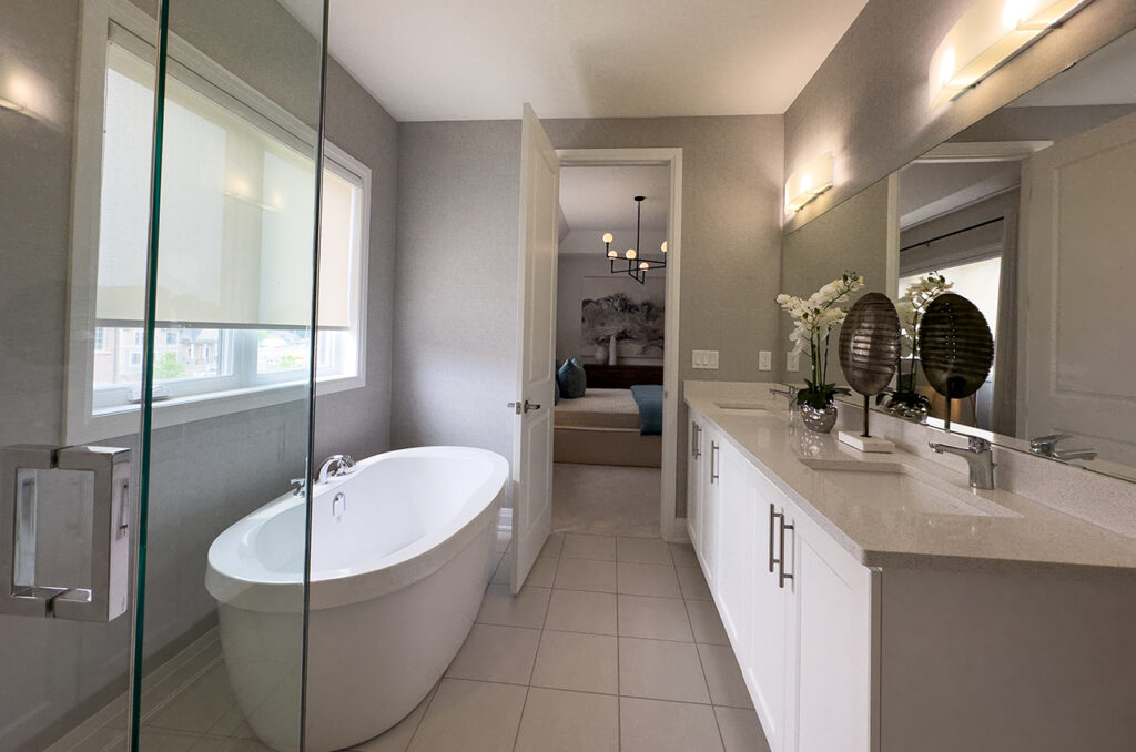 Ensuite bathroom with double sink, stand alone tub and walk in shower.